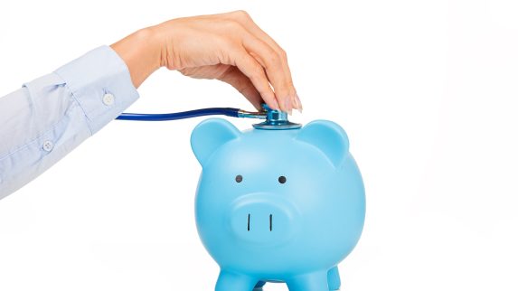 Piggy bank and stethoscope Isolated on white background.